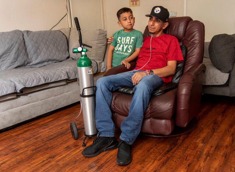 PACOIMA, CA-SEPTEMBER 8, 2023: Leobardo Segura Meza, 27, who suffers from silicosis, an incurable lung disease that affects workers who cut and polish artificial stone with high silica content, is photographed with his son Leo Gael Segura, 4, in his home in Pacoima.  (Mel Melcon/Los Angeles Times via Getty Images)